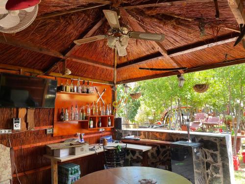 a bar in a restaurant with a ceiling fan at Casa Yachi Vama Veche in Vama Veche