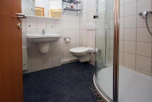 a bathroom with a sink and a toilet and a shower at Yachthafenresidenz-Wohnung-9209-897 in Kühlungsborn