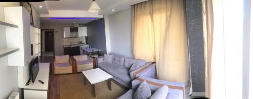 uma sala de estar com um sofá e uma mesa em FATIH - TUYAP APART'S em Kırac