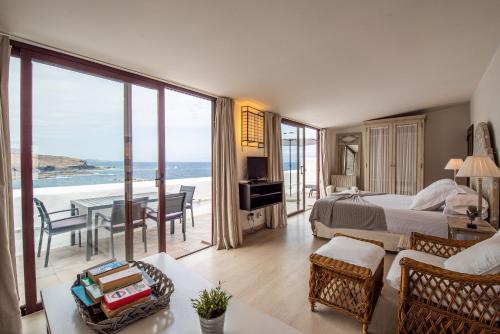 a bedroom with a bed and a view of the ocean at Isla Baja Suites in Garachico