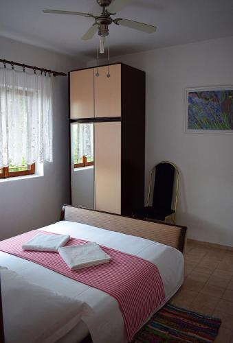a bedroom with a bed with two towels on it at Apartments by the sea Loviste, Peljesac - 262 in Lovište