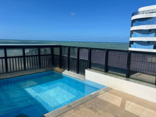 a swimming pool on the balcony of a building at NEO 1.0 in Maceió