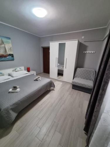 a bedroom with a bed and a chair in it at Family friendly seaside apartments Nevidjane, Pasman - 325 in Neviđane