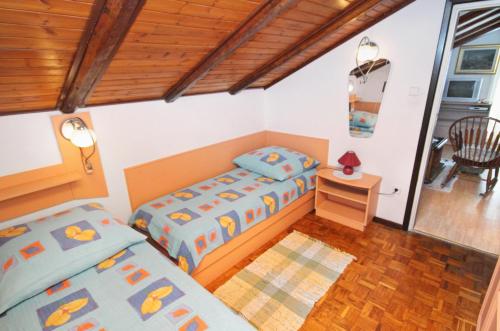 a bedroom with two beds and a table and a chair at Apartment Kornic 416b in Kornić