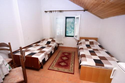 a room with two beds and a window at Apartment Biograd na Moru 368b in Biograd na Moru
