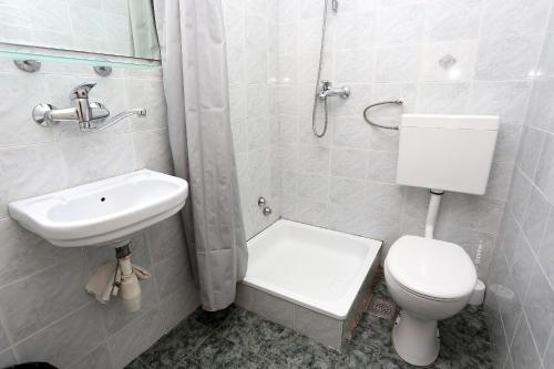 a bathroom with a white toilet and a sink at Apartments and rooms by the sea Trpanj, Peljesac - 258 in Trpanj