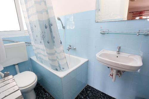 a blue bathroom with a toilet and a sink at Apartments and rooms by the sea Trpanj, Peljesac - 258 in Trpanj