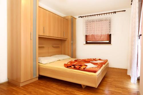 a small bedroom with a bed and a closet at Apartments and rooms by the sea Trpanj, Peljesac - 258 in Trpanj