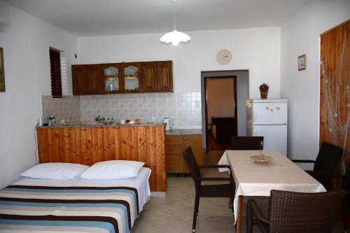 a room with two beds and a table and a kitchen at Apartments by the sea Luka Dubrava, Peljesac - 284 in Janjina