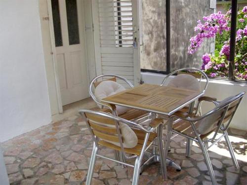 a wooden table and chairs in a room with a window at Apartments by the sea Orebic, Peljesac - 251 in Orebić