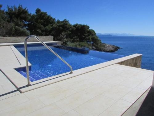 a swimming pool with a view of the ocean at Rooms with a swimming pool Cove Saplunara, Mljet - 401 in Maranovići