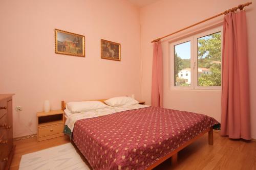 a bedroom with a bed and a window at Apartments and rooms by the sea Zaglav, Dugi otok - 393 in Sali