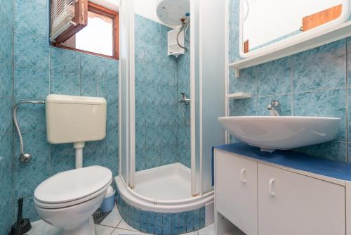 a blue bathroom with a toilet and a sink at Apartments by the sea Nin, Zadar - 290 in Nin