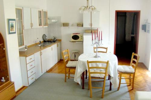 a kitchen with a table and chairs in a room at Apartments with a parking space Biograd na Moru, Biograd - 366 in Biograd na Moru