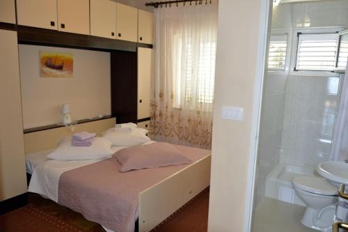 Schlafzimmer mit einem Bett, einer Dusche und einem Waschbecken in der Unterkunft Apartments by the sea Orebic, Peljesac - 269 in Orebić