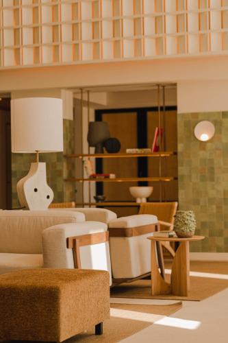 a living room with a couch and chairs at Aethos Ericeira in Ericeira