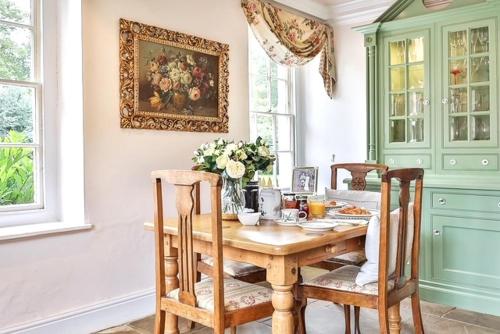 a dining room with a wooden table and chairs at Walcot Hall - Stunning Stately Home set in 27 acres of parkland and sleeping 16+ in Alkborough