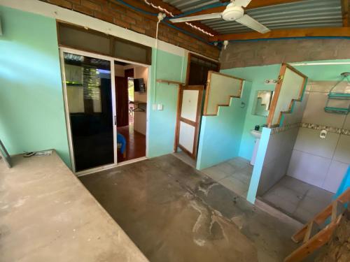 an empty room with blue and green walls at Lote 44 Guesthouse in El Zonte