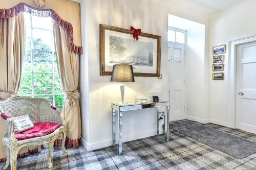 a room with a table and a chair and a window at Walcot Hall - Stunning Stately Home set in 27 acres of parkland and sleeping 16+ in Alkborough
