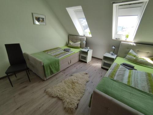 a bedroom with two beds and a rug at Apartment Linss in Gebesee