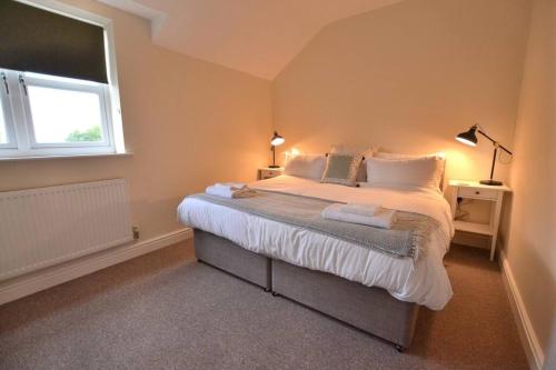 a bedroom with a large bed with a window at Park View in Hathern