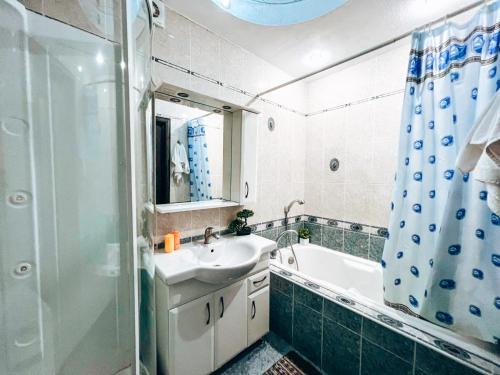 a bathroom with a tub and a sink and a shower at Квартира в центре Крещатика in Kyiv