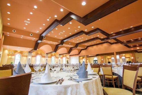a banquet hall with tables and chairs with hats on them at Hotel Abades Guadix in Guadix