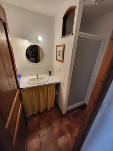 een badkamer met een wastafel en een spiegel bij La petite Maison 