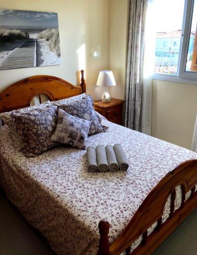 a bedroom with a bed with two towels on it at Las tres palmeras in Vinarós