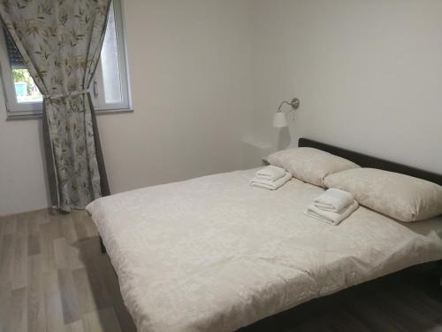 Ένα ή περισσότερα κρεβάτια σε δωμάτιο στο Apartment Smoljanac 12345c