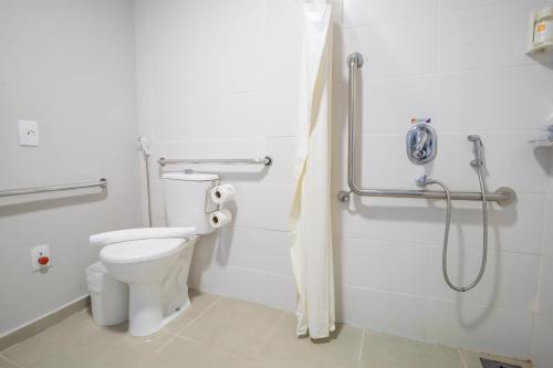 a bathroom with a toilet and a shower at Transamerica Fit Campo Grande in Campo Grande