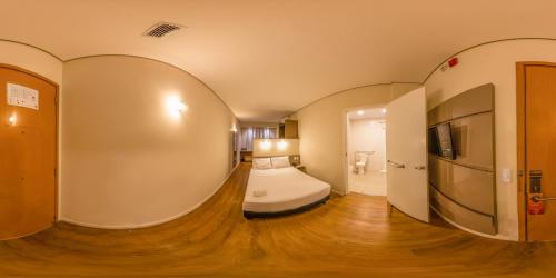 a hotel room with a bed in a hallway at Transamerica Fit Campo Grande in Campo Grande