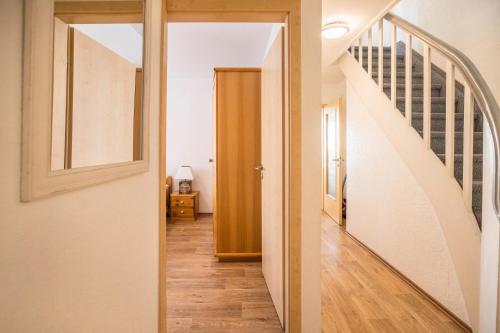 a hallway with a staircase and a door to a room at Seehaus Juist in Juist