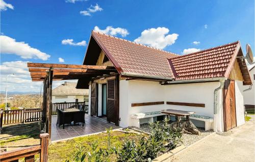 a house with a wooden roof and a patio at Beautiful Home In Stegersbach With Kitchen in Stegersbach