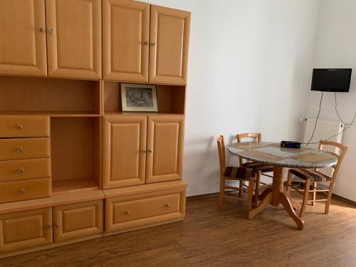 a dining room with a table and a large cabinet at Hotel am Freihafen in Duisburg