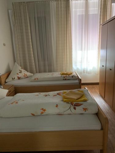 a bedroom with two beds and a window at Hotel am Freihafen in Duisburg