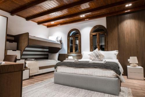a bedroom with two bunk beds and a bed with pillows at Vila Helen in Voskopojë