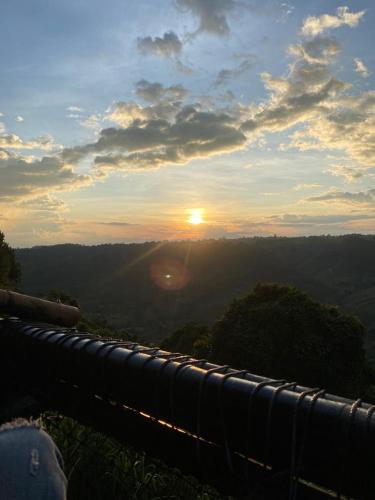 a view of the sunset from the top of a mountain at HakunaMatata glamping Pumba in Salento
