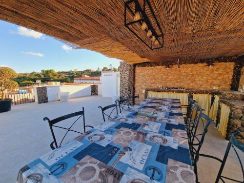 a row of long tables in a building with a roof at Casa Geloso in Ustica