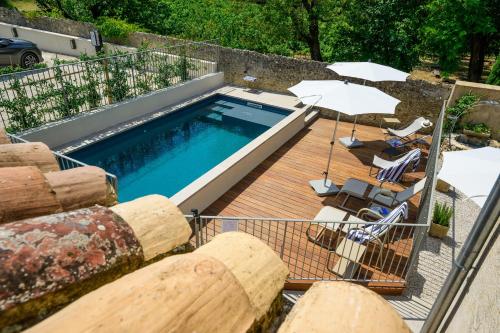 a swimming pool on top of a wooden deck at Villa Sainte Anne in Gigondas