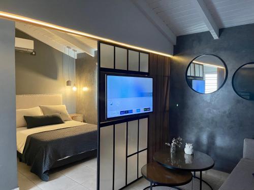 a bedroom with a bed and a tv on a wall at Loft 2023 in Villa Carlos Paz