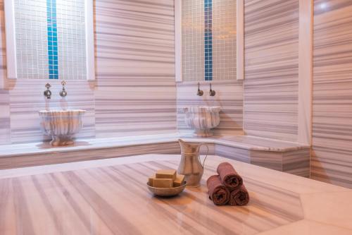 a room with two sinks and a wooden floor with a bowl of soap at Sueno Hotels Beach Side in Side