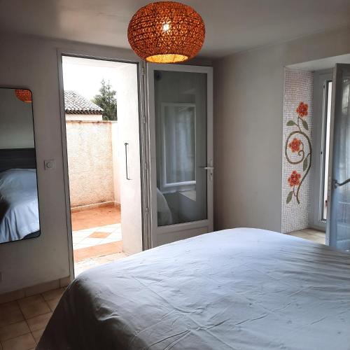 a bedroom with a large bed and a glass door at Campaneta in Saint-Martin-de-Brômes