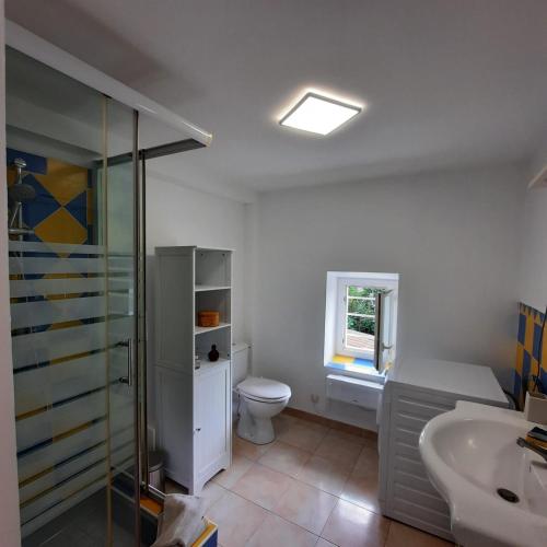 a bathroom with a toilet and a sink at Campaneta in Saint-Martin-de-Brômes