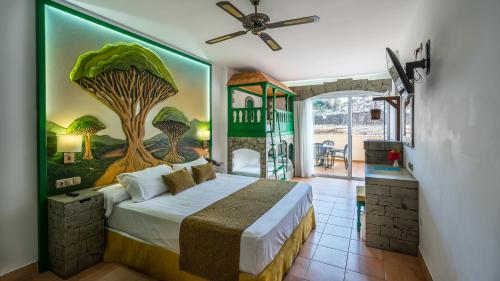 a bedroom with a bed with a painting on the wall at Blue Sea Costa Jardin & Spa in Puerto de la Cruz