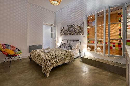 une chambre avec un lit, une chaise et une fenêtre dans l'établissement NOCNOC- Le Fortunio, à Marseille