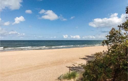 a sandy beach with the ocean in the background at 3 Bedroom Pet Friendly Home In Choczewo in Choczewo