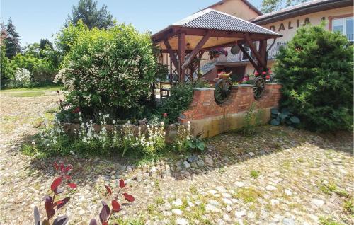 a garden in front of a house with a gazebo at 3 Bedroom Pet Friendly Home In Choczewo in Choczewo