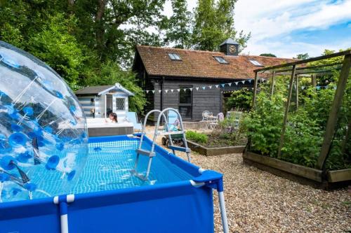 a water slide in a backyard with a house at Broombank in Burley