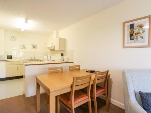 a kitchen and dining room with a table and chairs at Flat 33 - Marine Court in Littlehampton